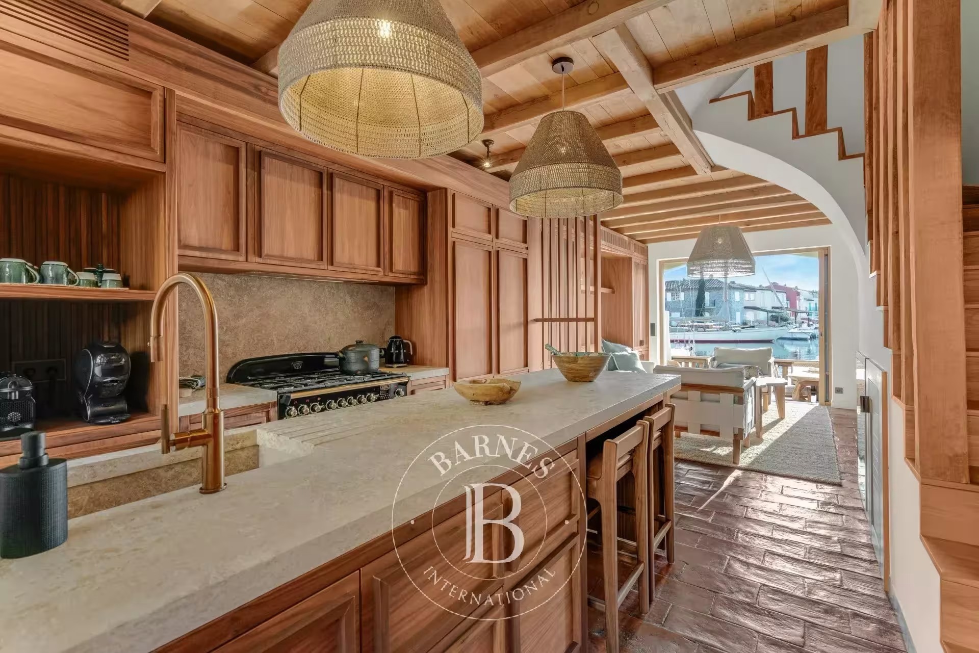 Renovated cottage kitchen with wood beam ceiling and a marina view in Port Grimaud, France